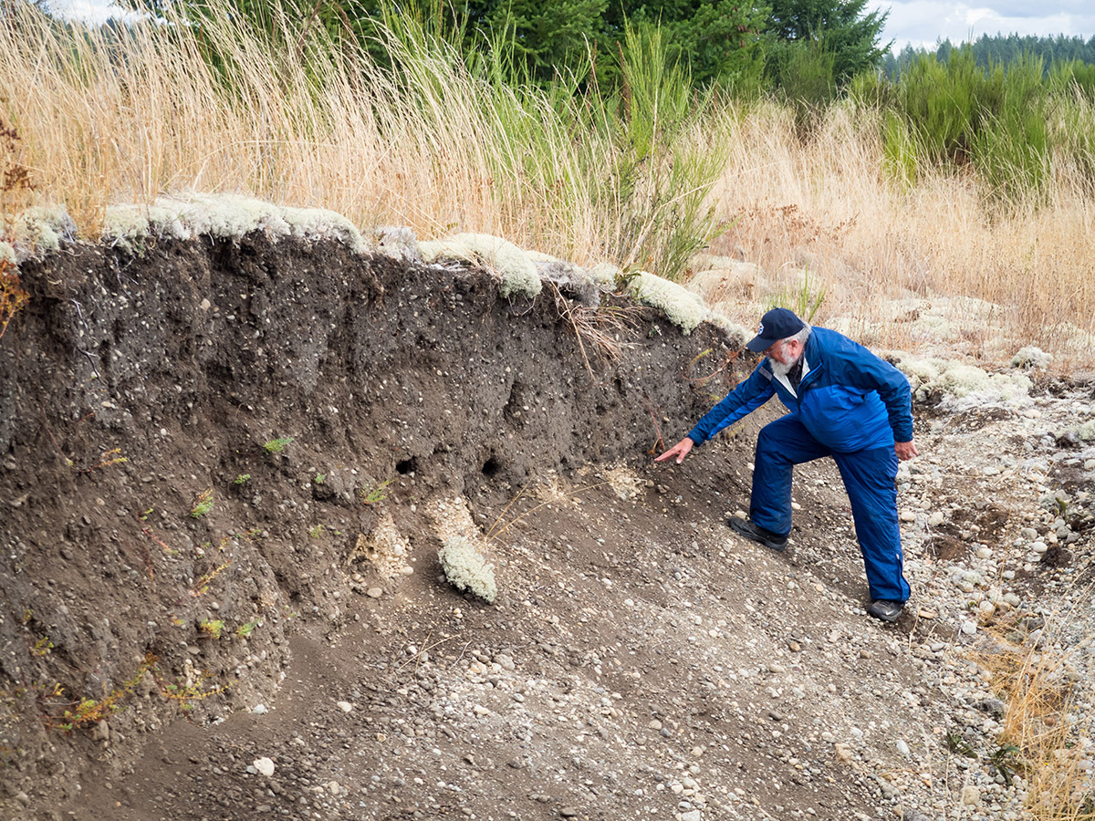 Geologist Tim Walsh examines a cross section of a Mima mound